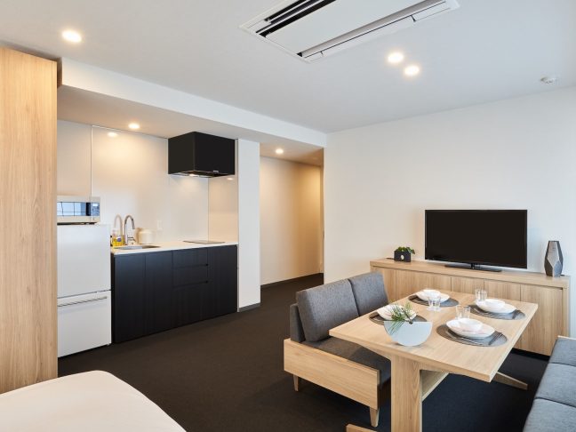 Example of a spacious MIMARU guest room equipped with a kitchen and dining space, allowing families to relax and cook their own meals.